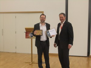 Chris receiving his trophy for Best Speaker award.