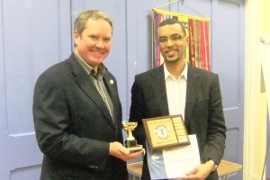 Evaluation Champ Yohan receiving his certificate & trophies from Mark.